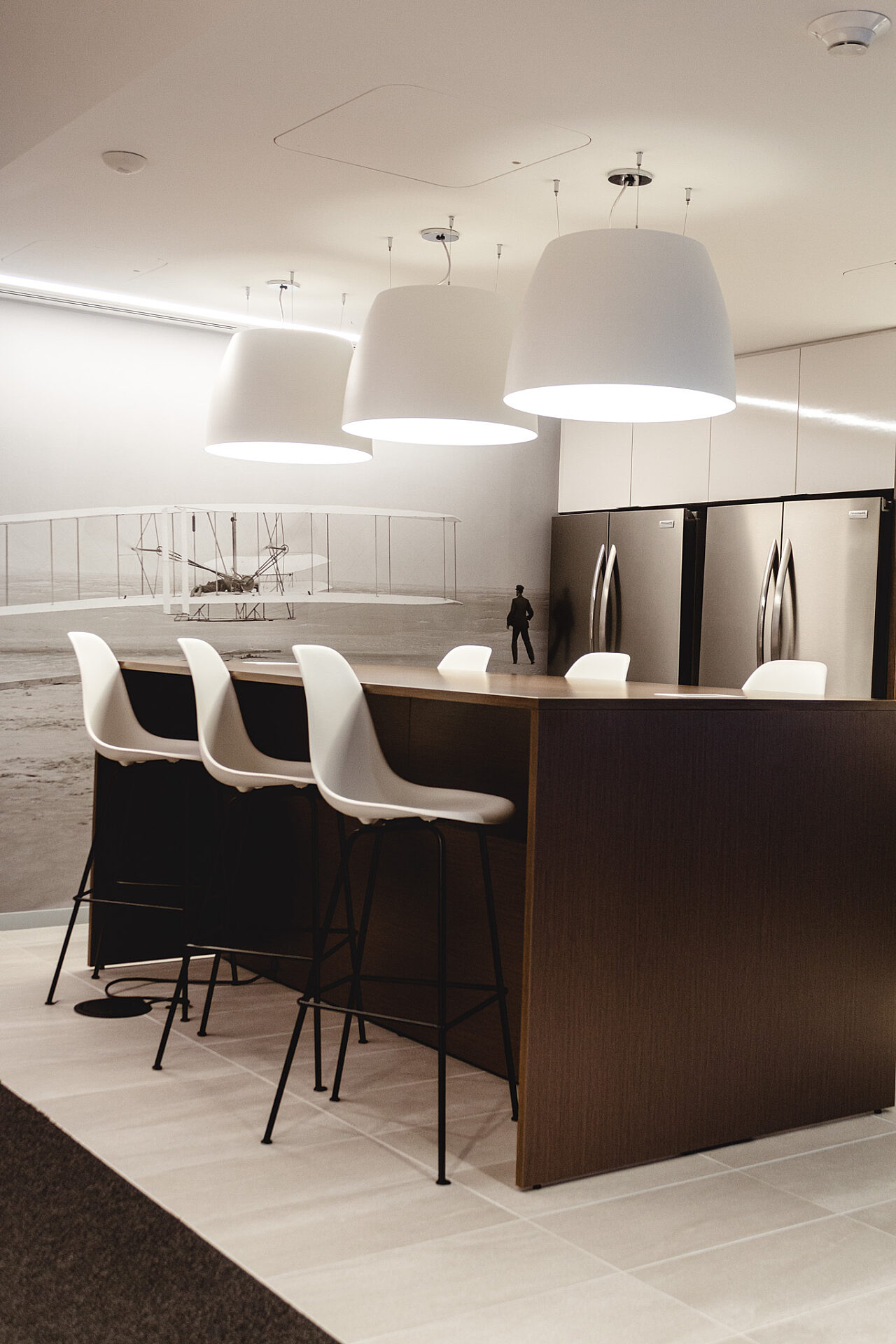 A bar height table with stools surrounding it