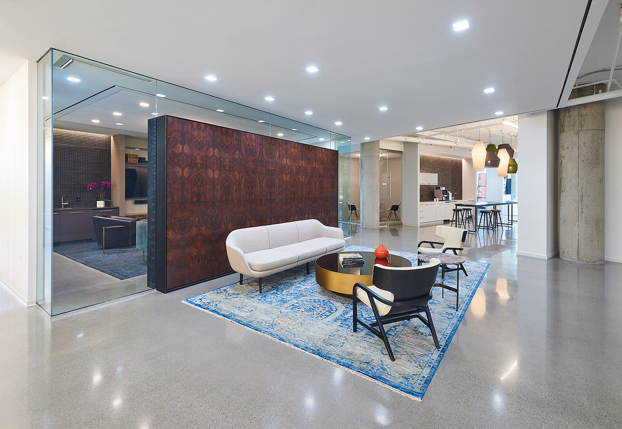 A lounge set up in front of a partial height decorative wall