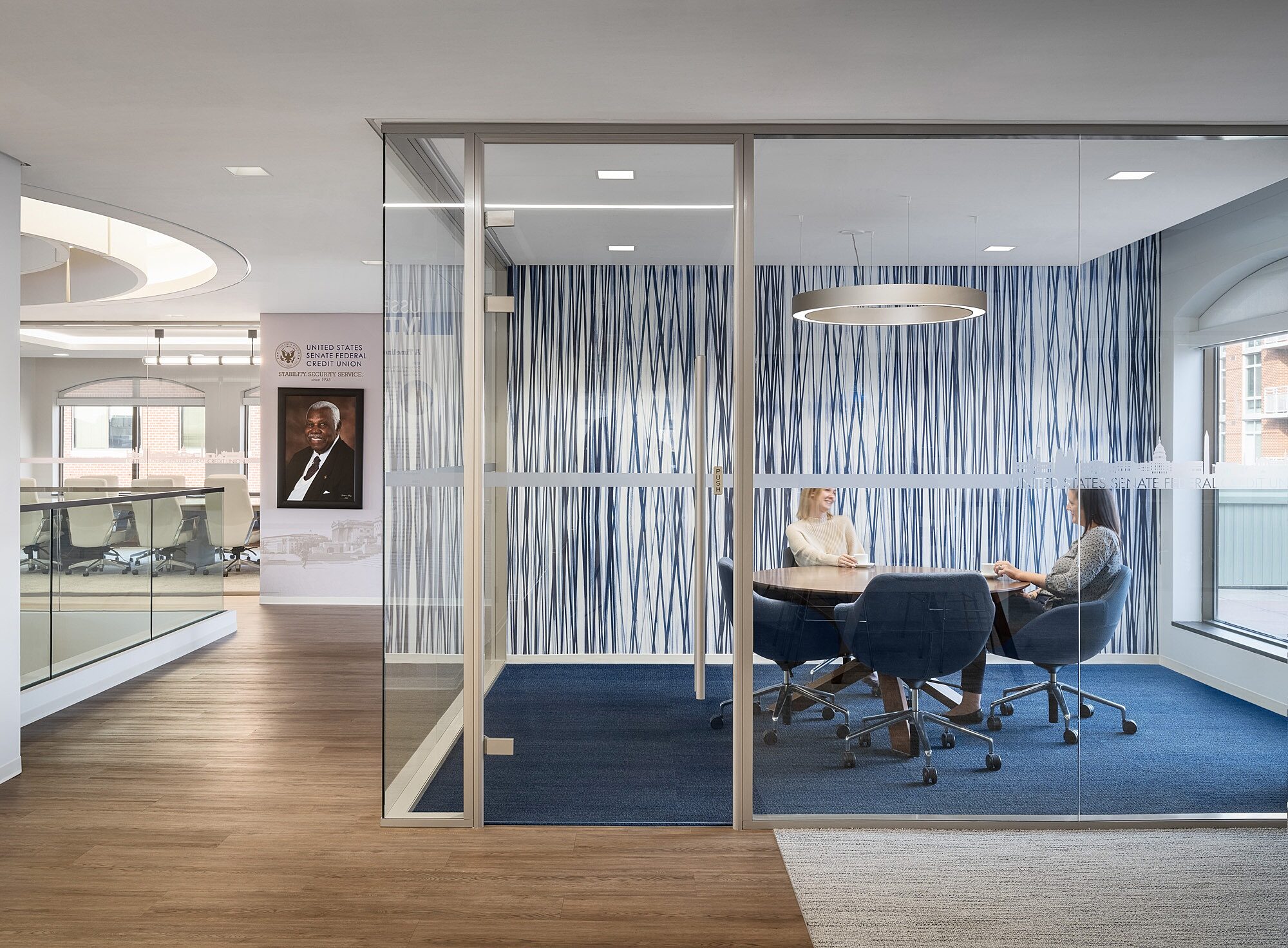 A room with glass walls and a table and chairs inside