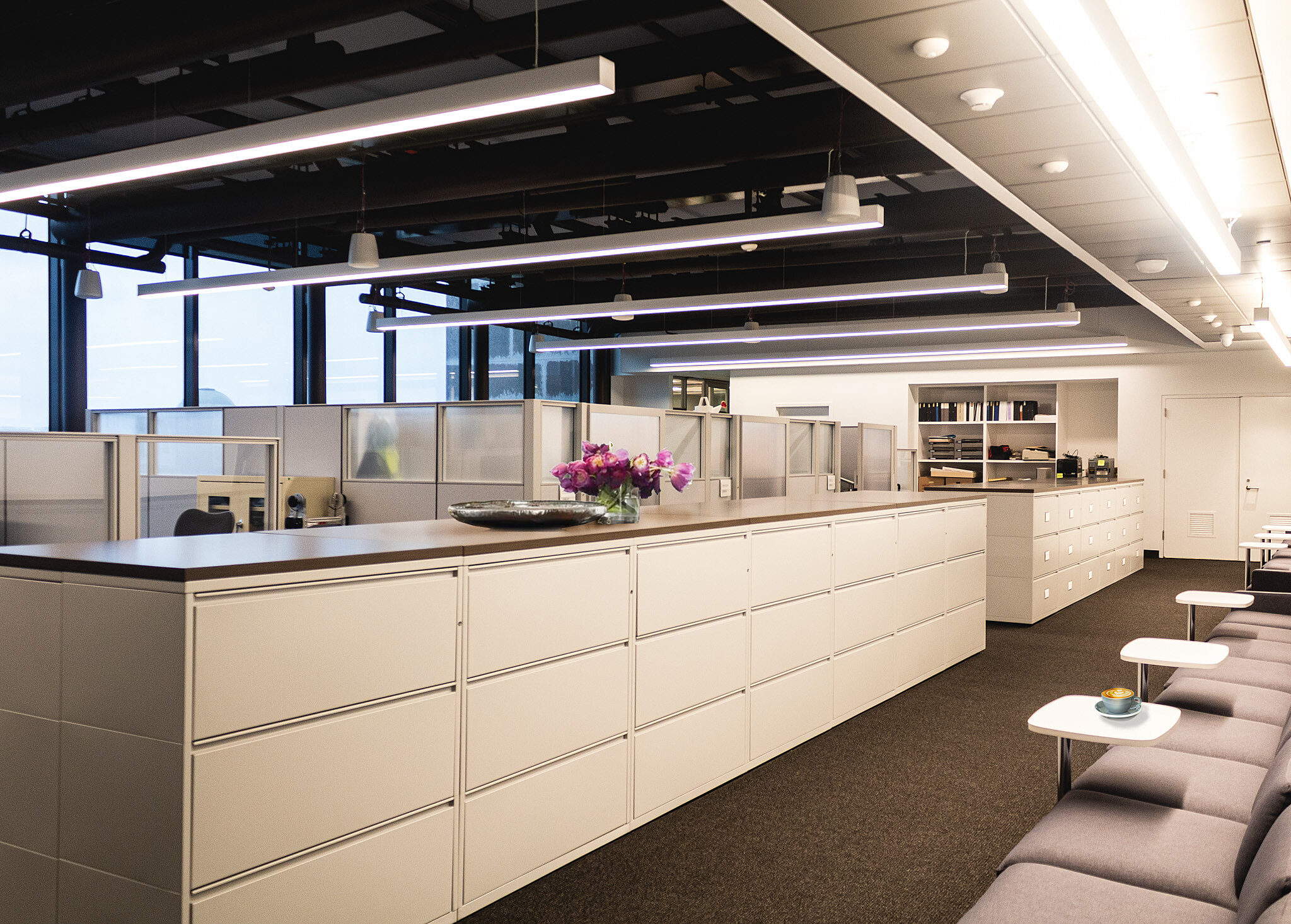 A row of lateral files across from a row of seating.