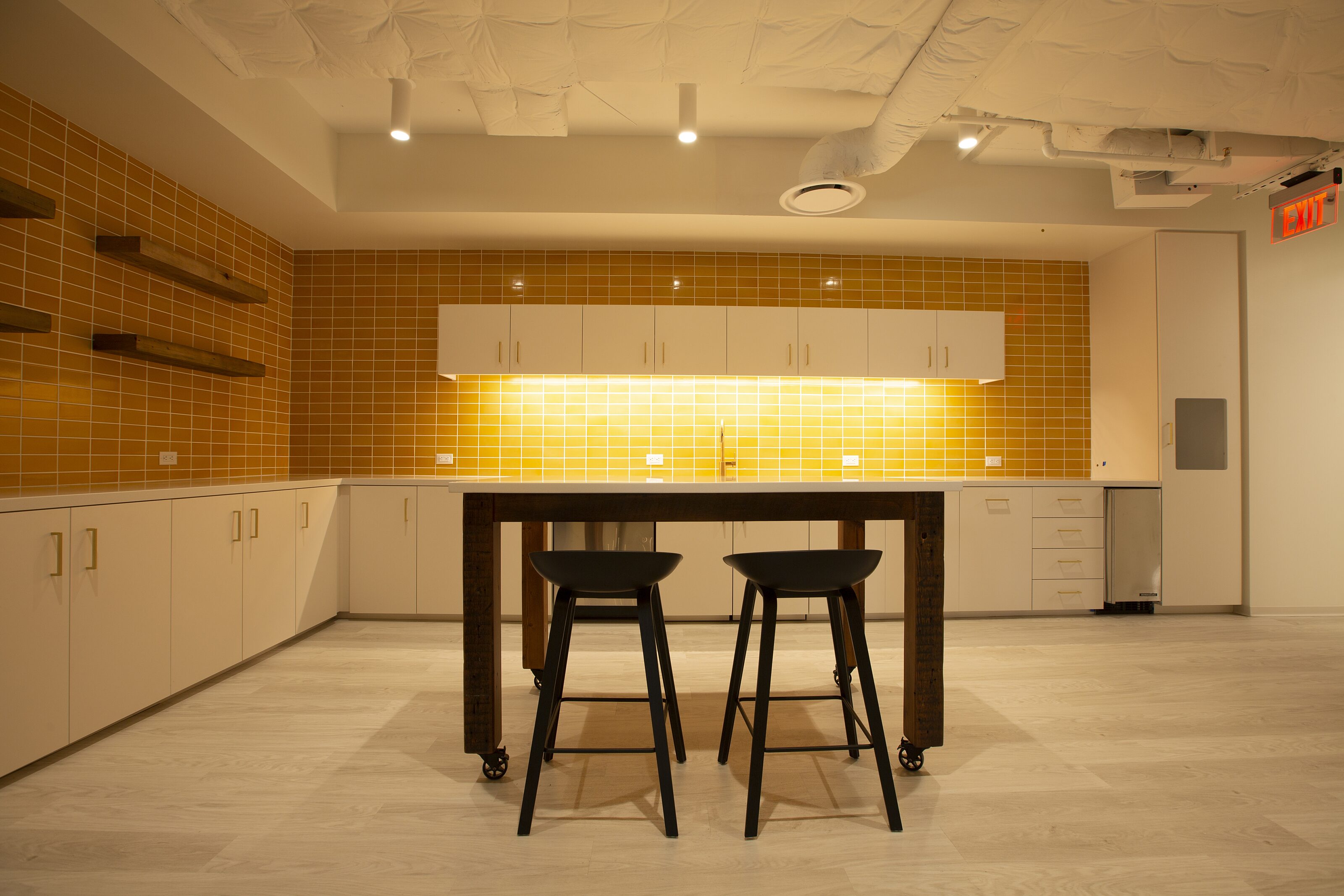 A high table with stools in a pantry with simple design