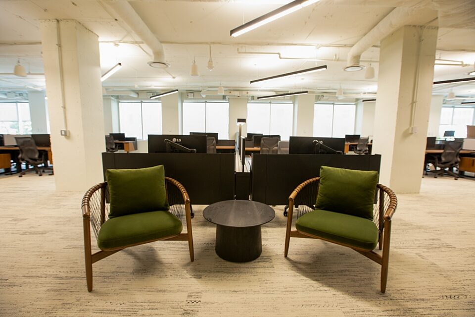 A lounge grouping adjacent to clusters of workstations